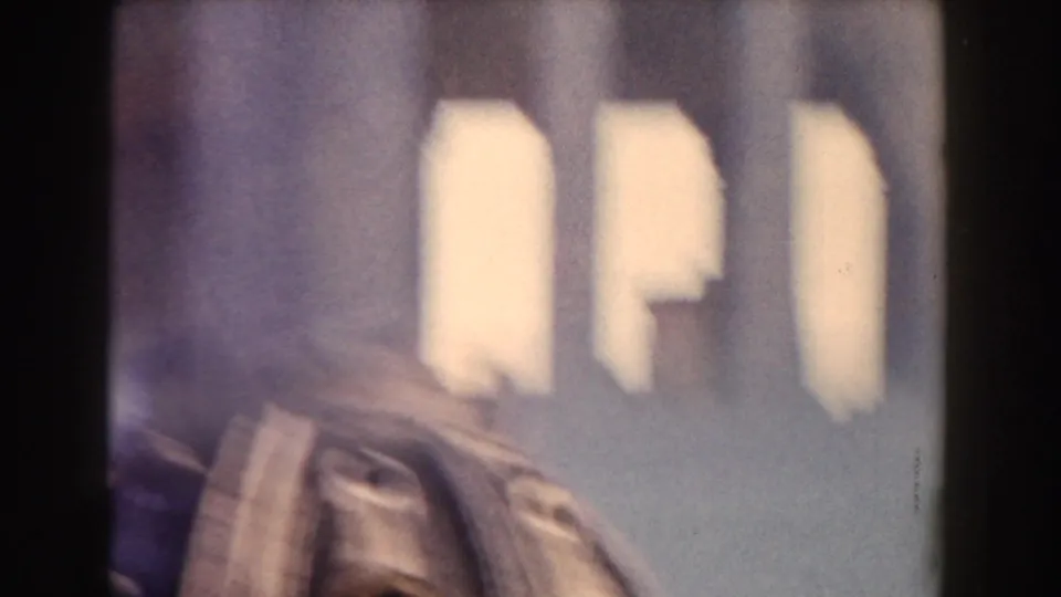 1959 Rome 8mm frame showing a blurred partial dome and pale architectural forms with strong film-edge shadowing.