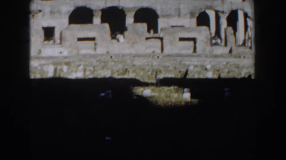 1959 Rome frame of the Colosseum's upper arches, partly blocked by dark foreground structure.