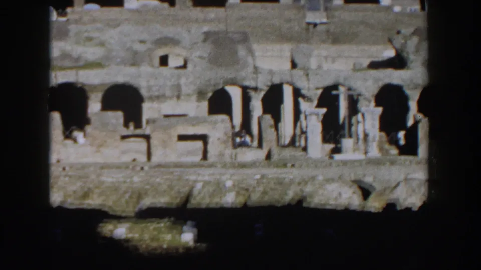 1959 Rome frame showing damaged Colosseum arches and pale stone surfaces within a dark border.