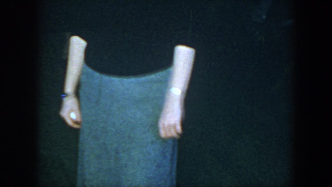 In the 1952 Houston clip, the woman is shown mostly from torso to feet, emphasizing the gray skirt and dark loafers.