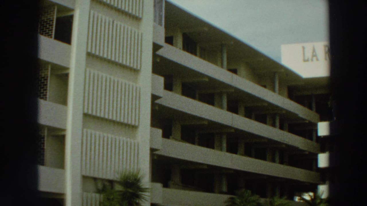 Multi-story building facade with balconies and part of the La Rada sign at the upper right.