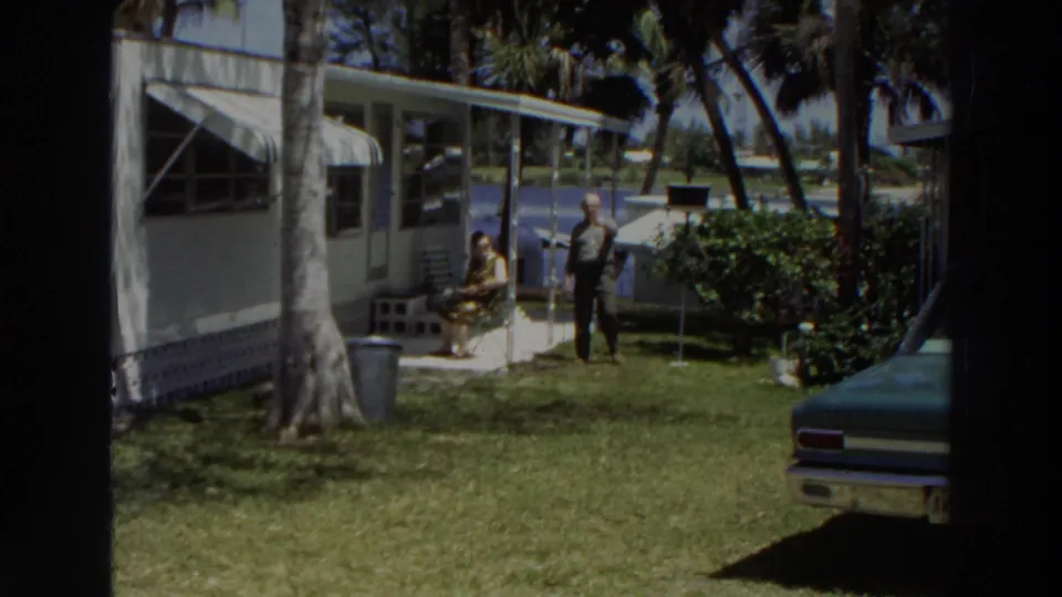 A wider 1966 Puerto Rico view shows a woman seated by the porch and a man standing near a white mobile home under palm trees.