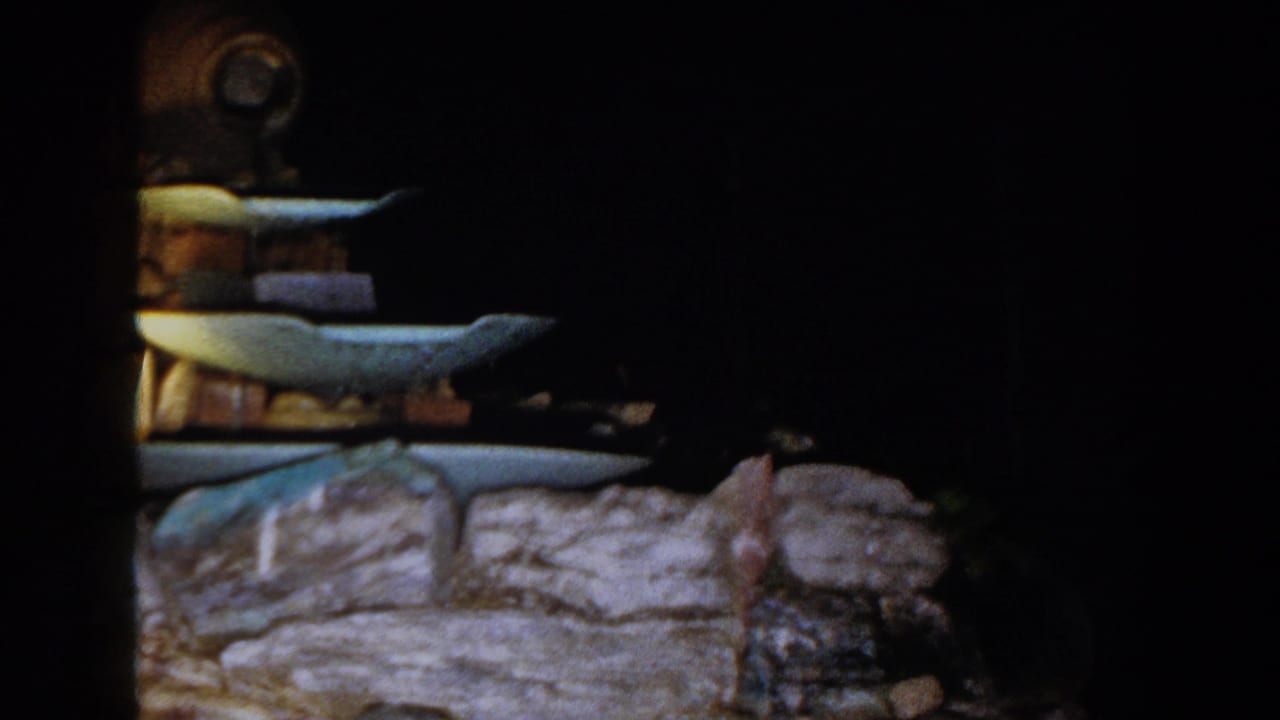 Tiered decorative fountain or display with stone base against a dark background.