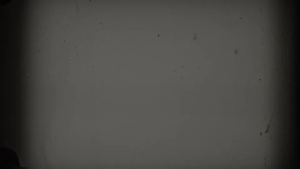 Dark damaged 8mm frame from the Brighton, Michigan clip, showing gate shadows, dust, scratches, and no clear scene detail.