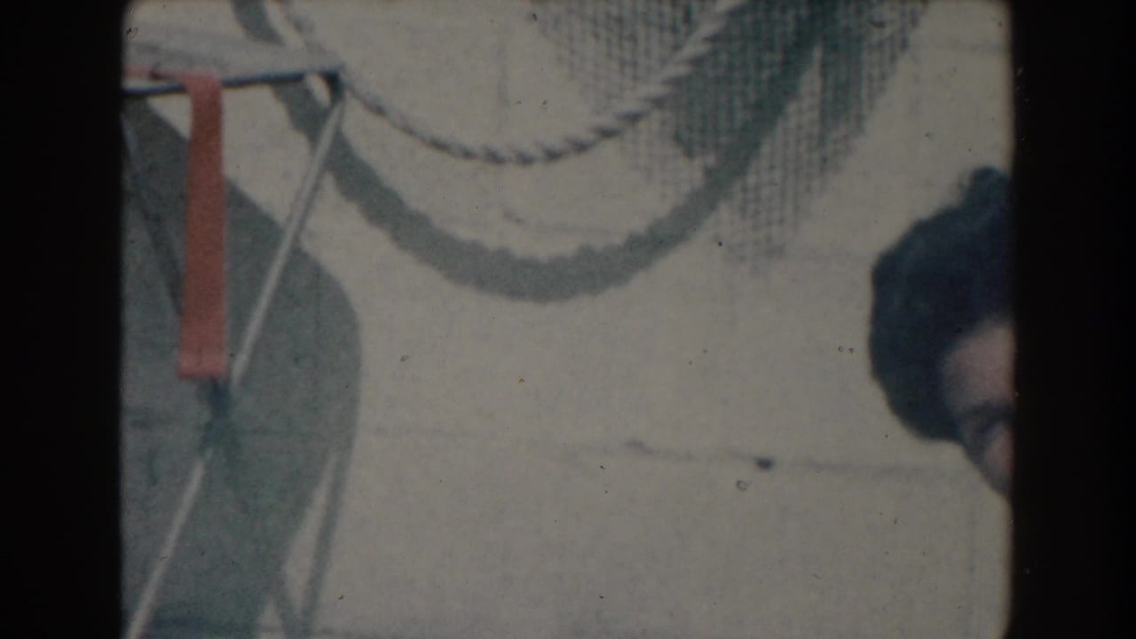 Poolside chair frame and rope are visible, with part of a face at the right edge.