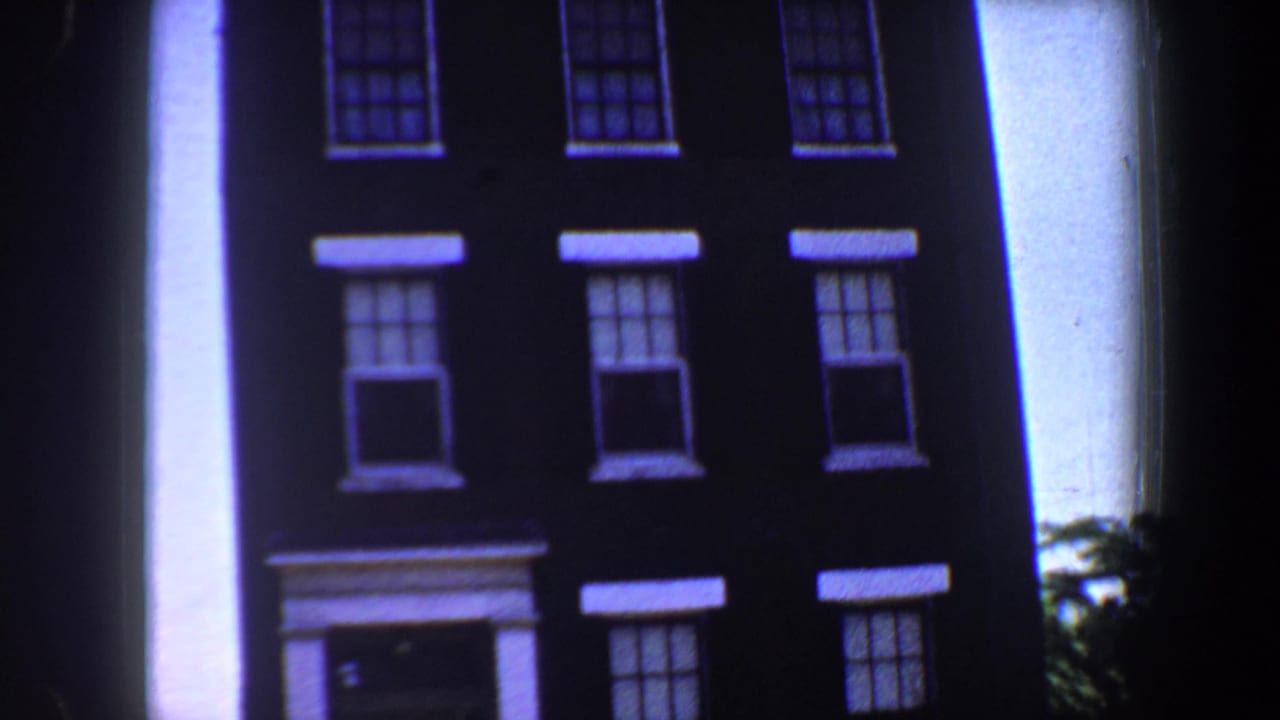 1964 Saint Louis exterior view of the same dark masonry building, with symmetrical windows and pale trim visible in bright daylight.