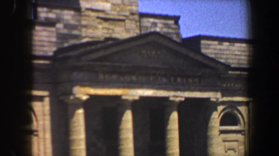 St. Louis public building exterior with classical columns, an arched window, stonework, and visible 8mm frame edge.