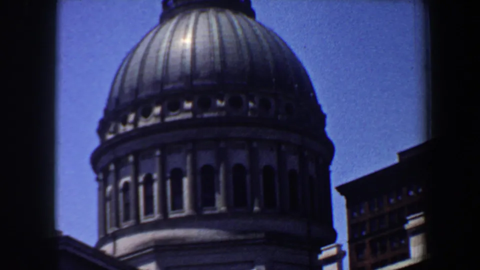 A historic-looking Saint Louis dome appears in a fuller view, with arched drum details and a neighboring building at the edge.