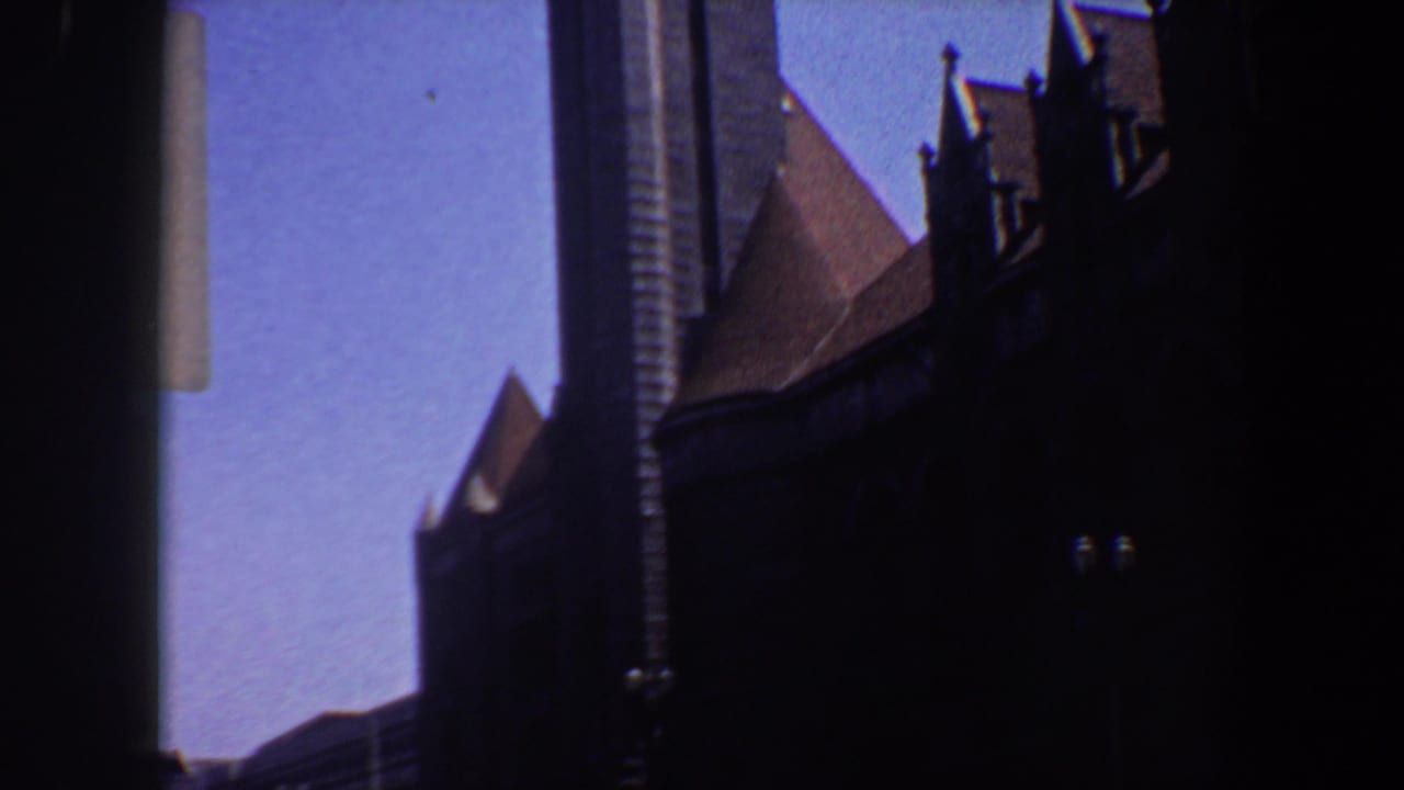 1964 Saint Louis frame with a Gothic-style church roofline and tower partially blocked by a dark vertical edge.