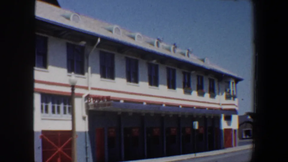 1964 Saint Louis view of a white Busch Stadium frontage with red trim, red doors, upper windows, and a streetlamp.