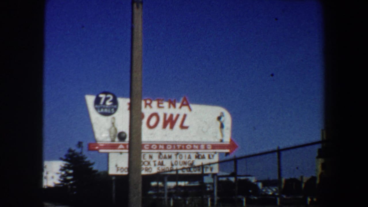Arena Bowl sign partly blocked by a pole and fence.