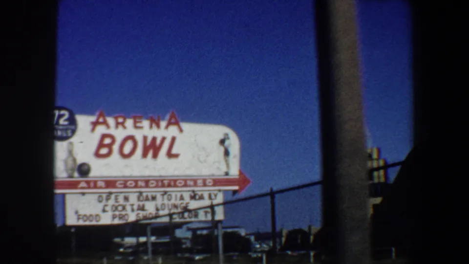 1964 St. Louis close view of the Arena Bowl sign with marquee lettering, fence, sky, and film-frame border.