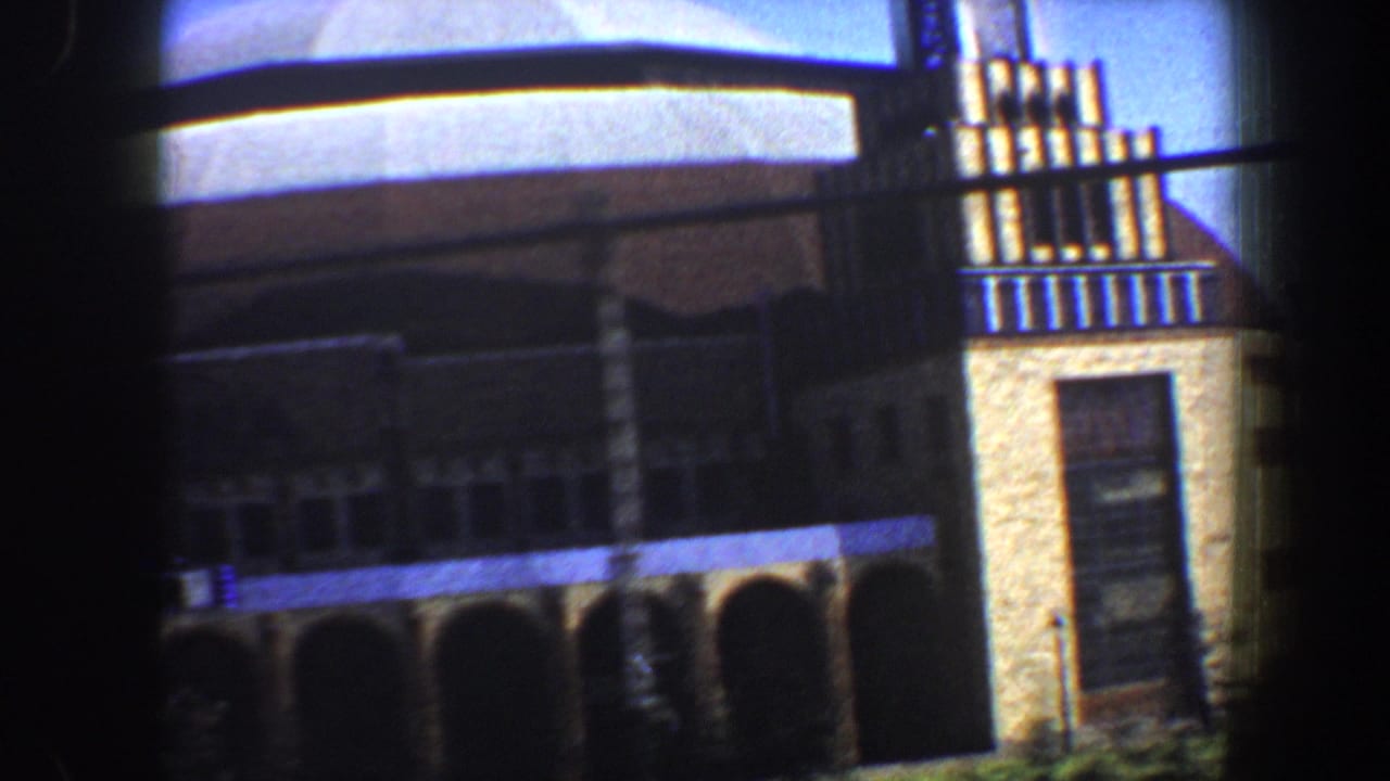 1964 Saint Louis frame of a domed building exterior, with arched openings below and a vertical masonry section at the right edge.