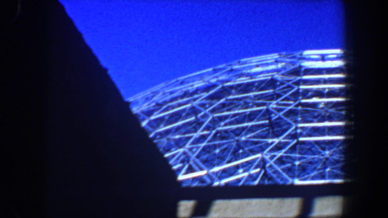Metal lattice dome partly obscured by dark foreground framing.