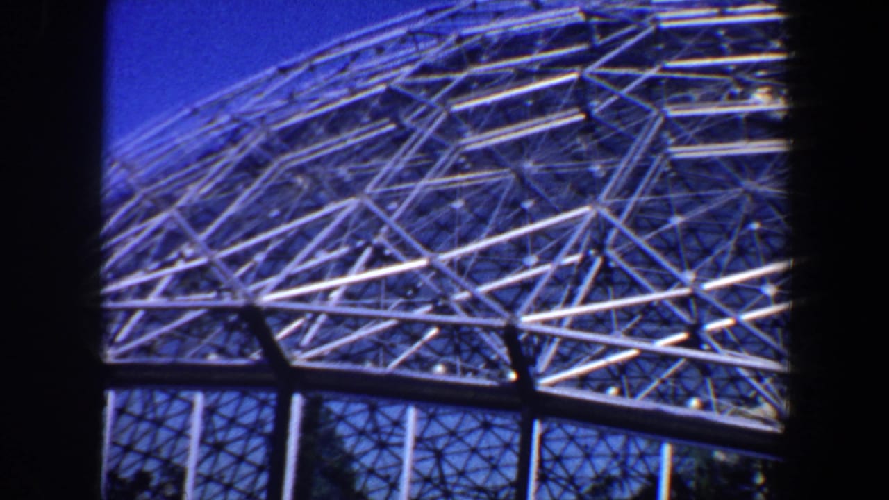 Geodesic dome roof structure framed by dark vertical edges.