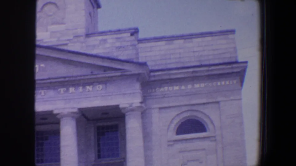 1964 St. Louis frame of the building's upper facade, showing stone columns, Latin lettering, Hebrew text, and an arched window.