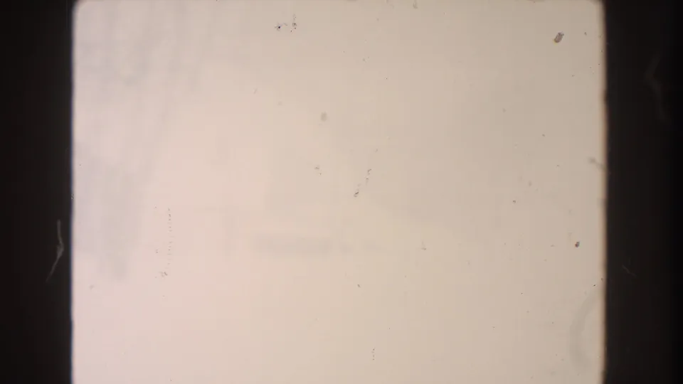 A pale Dearborn winter frame from 1961, with barely visible residential shapes, snow, dust marks, and 8mm frame borders.