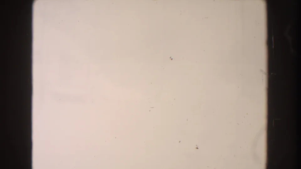 Near-abstract 1961 Dearborn winter frame showing pale snow tones, faint background forms, dust, and dark 8mm gate edges.