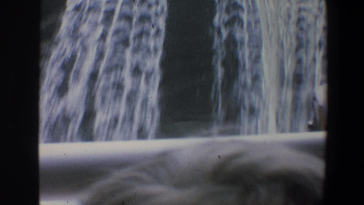 Cascading water over a dark surface with a pale barrier and 8mm frame edges.