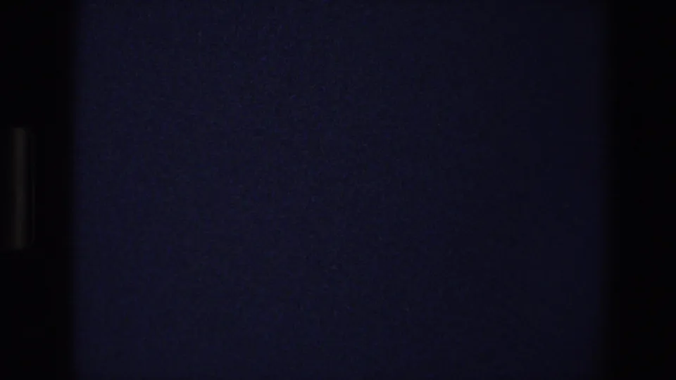 Very dark 1973 Walt Disney World home-movie frame with blue-black exposure, grain, and no clearly identifiable subject.