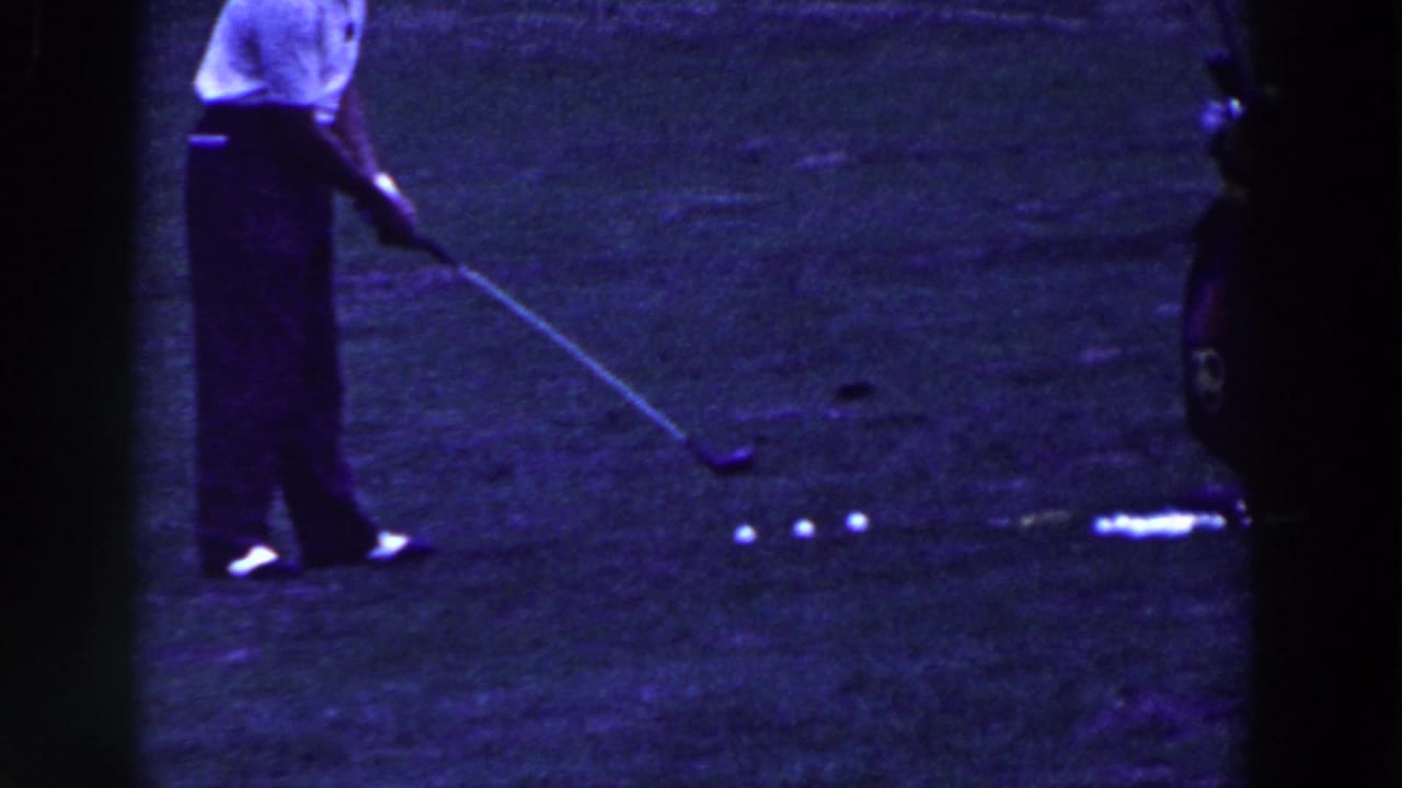 In metadata-supported 1961 Ridgefield, New Jersey footage, a man in a white shirt stands over golf balls on grass.