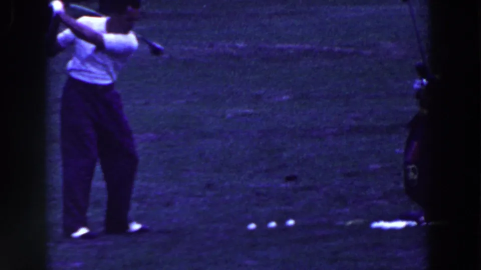 In Ridgefield, New Jersey home-movie footage from 1961, a man in a white shirt swings a golf club on grass.
