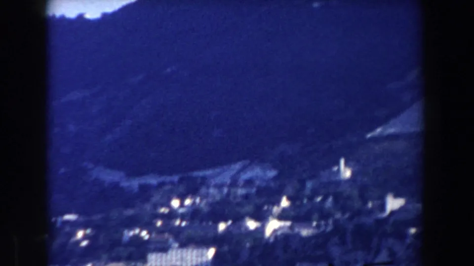 Likely Gibraltar hillside view from 1959, with pale buildings scattered below a rugged mountain backdrop.