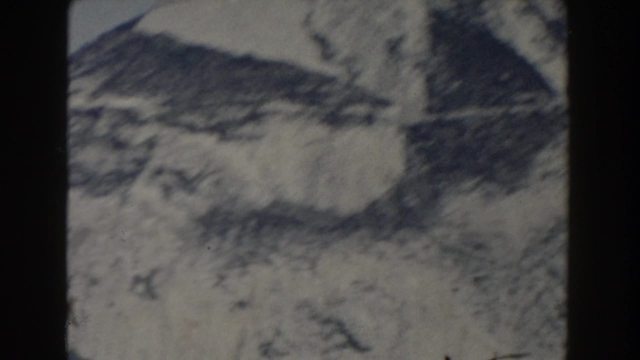 1959 Gibraltar 8mm view of a blurred mountain ridge and pale rocky face, seen through soft home-movie exposure.