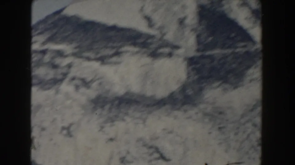 1959 Gibraltar 8mm view of a blurred mountain ridge and pale rocky face, seen through soft home-movie exposure.