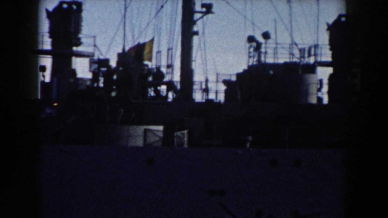 Dark ship superstructure and mast equipment silhouetted against the sky.