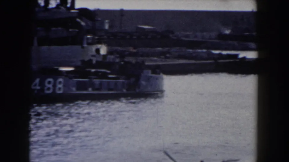 Gibraltar harbor footage shows overlapping naval vessels, including a hull number that appears to read 498 or 1498, with calm water in front.