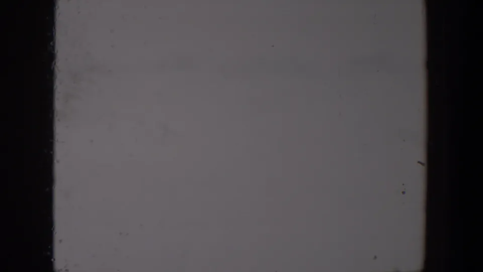Overexposed black and white 8mm frame from the Lubbock reel, with no discernible subject and visible film wear.
