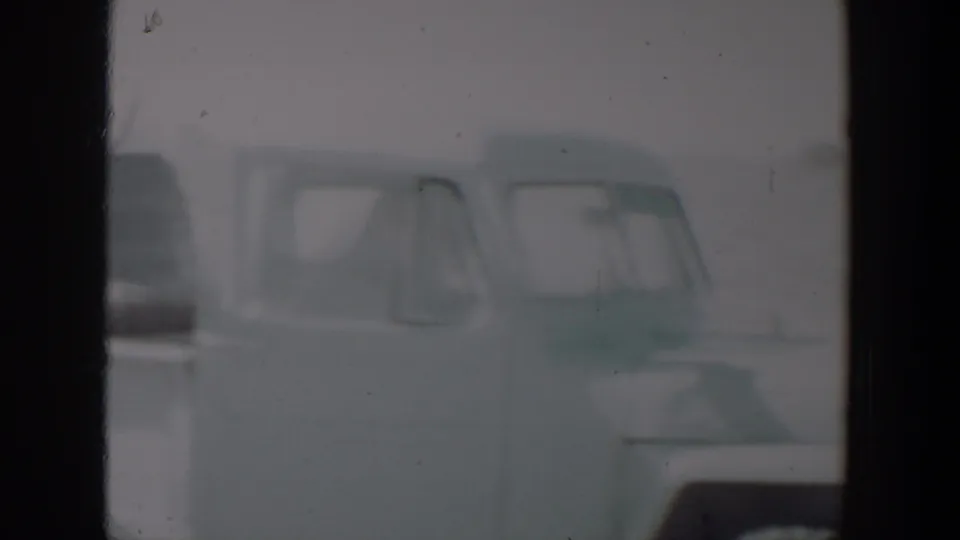 The final frame holds on the light-colored pickup, with its cab windows and truck bed softly rendered by faded 8mm film.