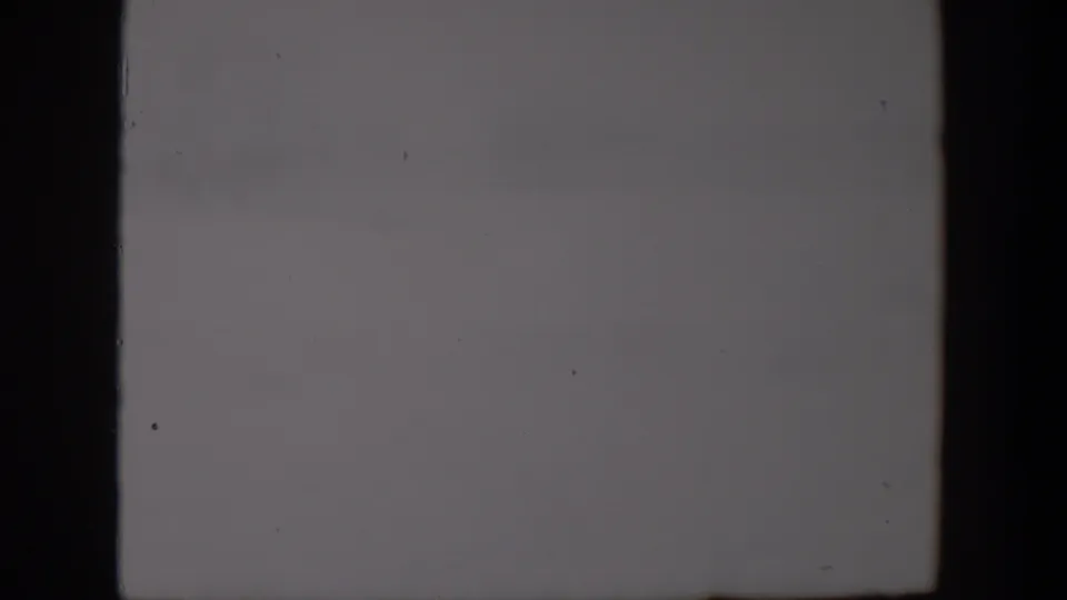 Gray cloudy sky from the 1957 Lubbock 8mm clip, with subdued exposure and visible film texture.