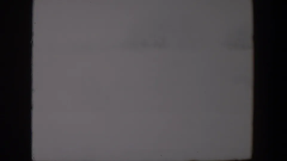 Muted overcast sky from the 1957 Lubbock 8mm footage, with visible grain and subdued exposure.