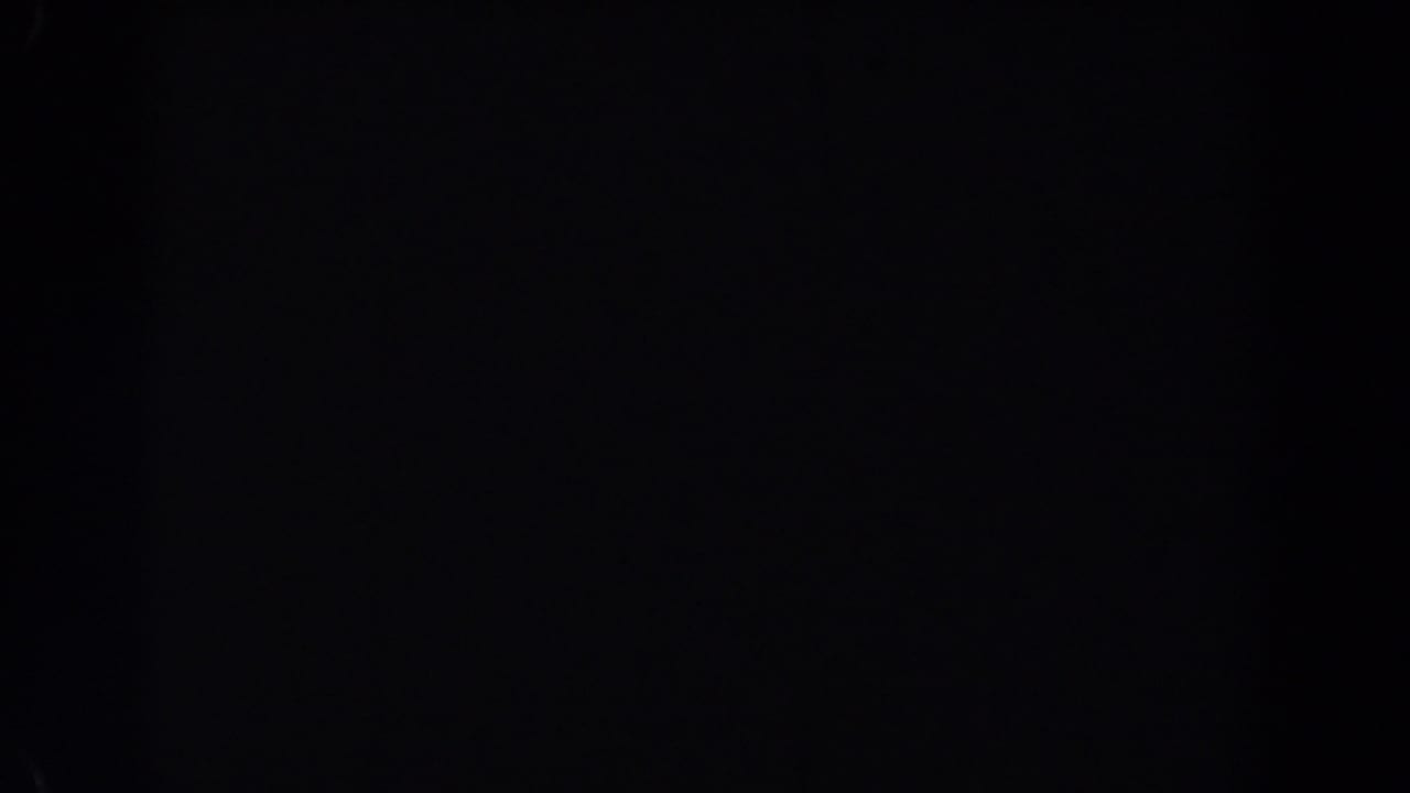 Near-black 1962 Van Nuys 8mm home-movie frame with faint grain, slight tonal variation, and no identifiable subject.