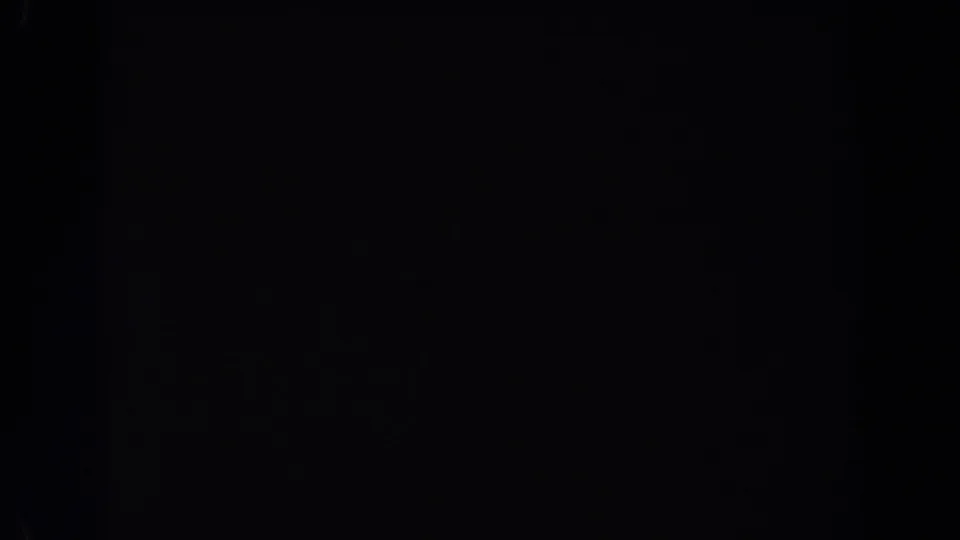 Underexposed 1962 Van Nuys 8mm home-movie frame showing darkness, grain, and soft edge falloff without identifiable figures or objects.