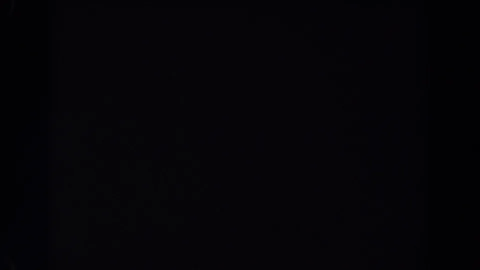 Nearly black 1962 Van Nuys 8mm frame with faint film texture, minor specks, and no discernible subjects or setting.