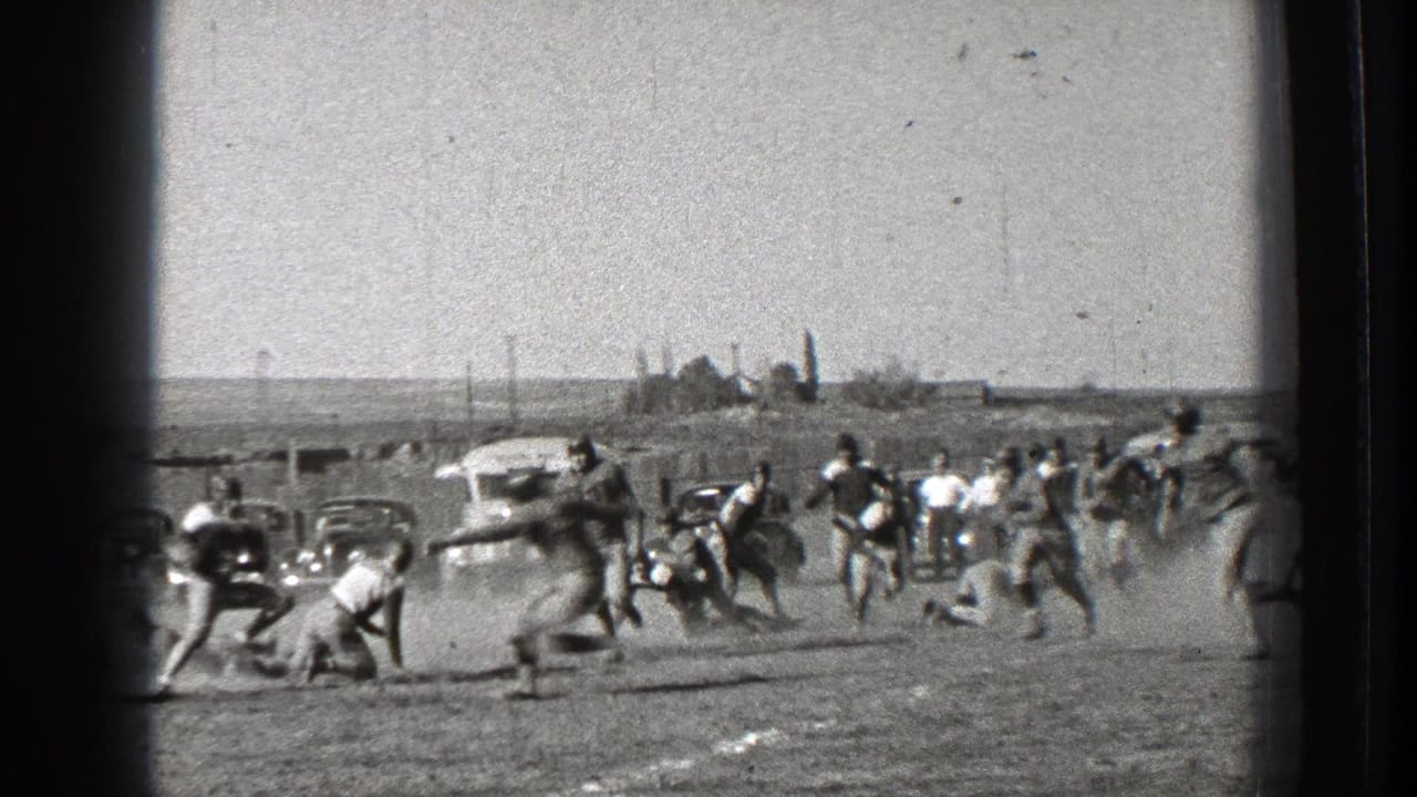 Washington 1939 football action with several players tackling or reaching for the ball as dust rises near the sideline.