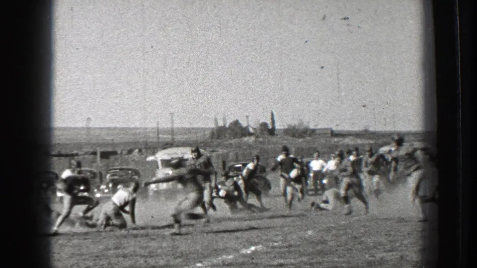 Washington 1939 football action with several players tackling or reaching for the ball as dust rises near the sideline.