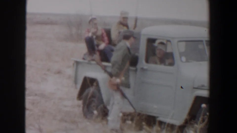 Hunters near Lubbock, Texas appear beside and inside a vintage pickup during a 1956 hunting outing.