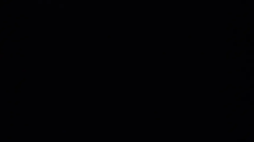A mostly dark 8mm contact-sheet frame with no clearly readable subject visible in this quadrant.