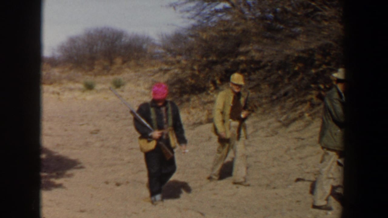 Near the end of the clip, adult hunters in hats and jackets cross a dry Lubbock field with rifles and scrub vegetation around them.
