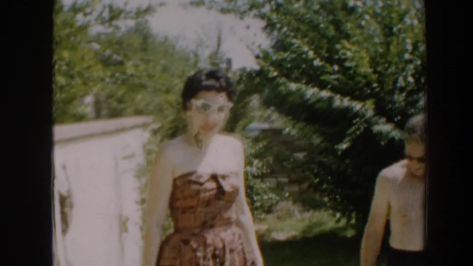 The final frame shows the woman in sunglasses centered in the North Hollywood yard, with the shirtless man cropped at the right edge.