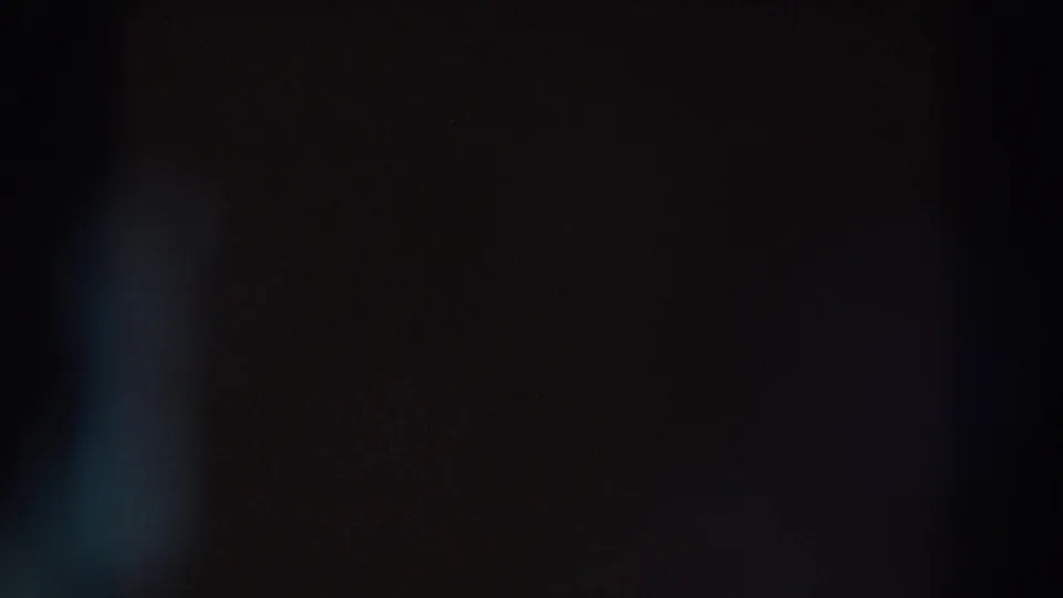 Mostly black 8mm frame with a muted blue vertical flare and grain, supported by metadata as Madison, Wisconsin, 1966.