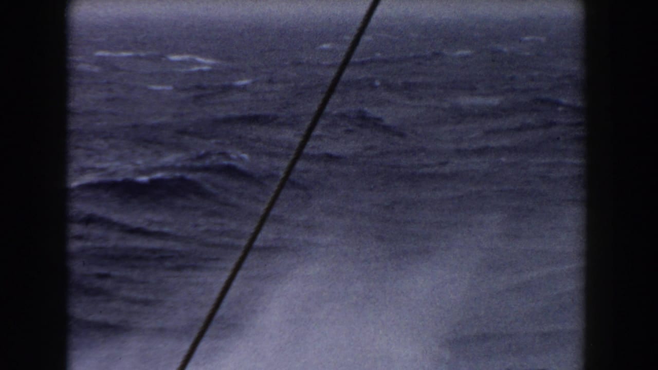 Choppy sea with a diagonal pole or cable crossing the frame.