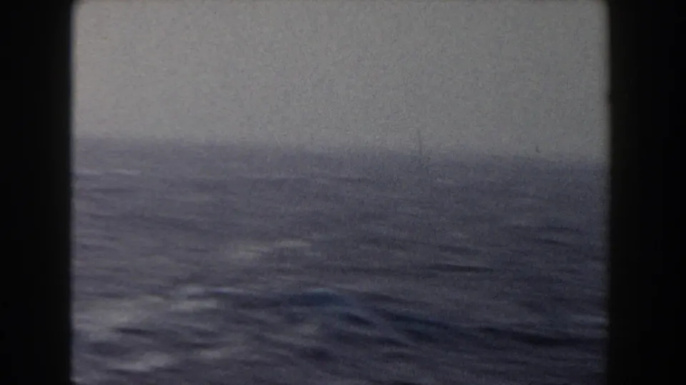 1959 8mm shipboard view of dark Atlantic water and low whitecaps under a gray horizon.