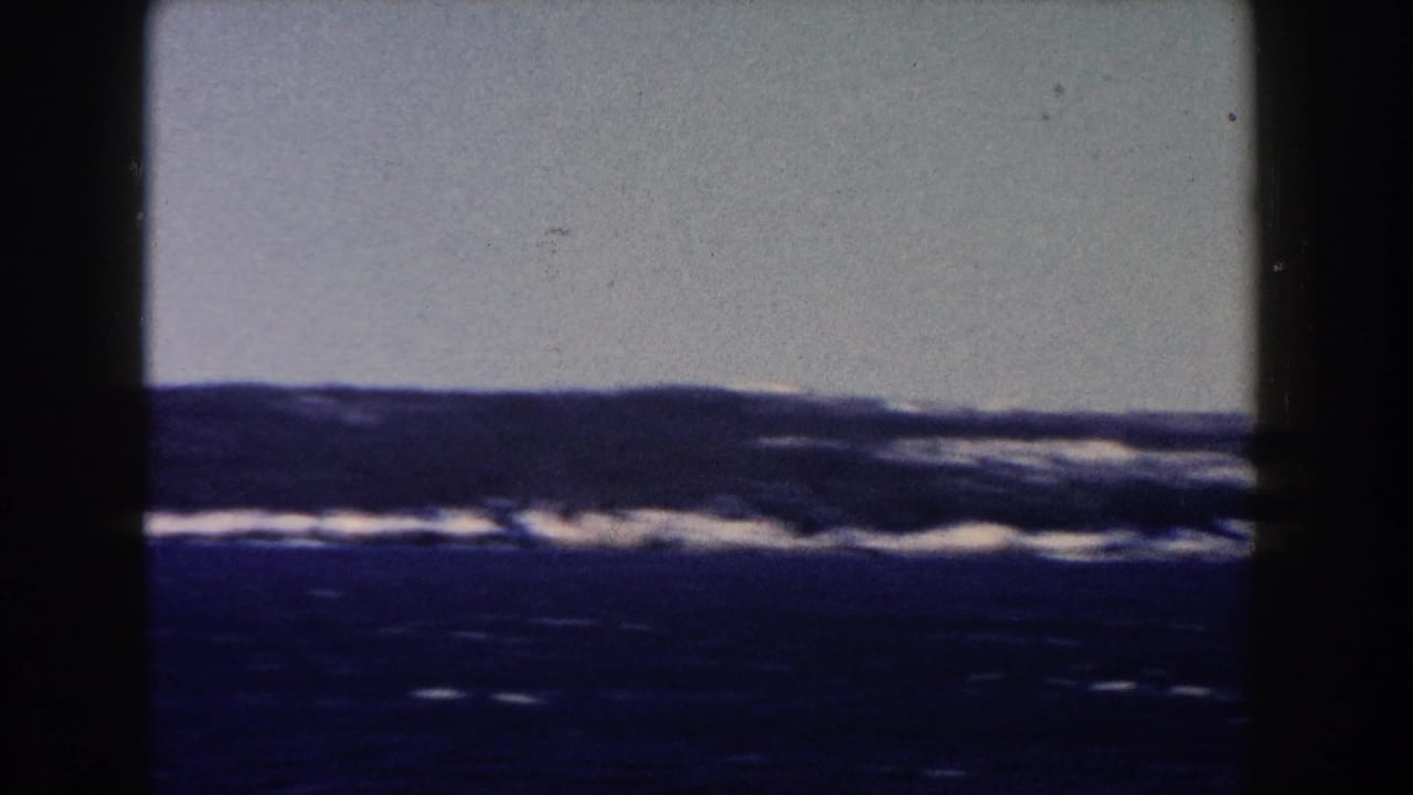 White-capped water and distant horizon under a pale sky.