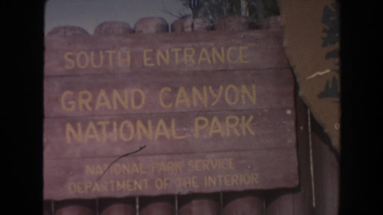 Wooden sign reads South Entrance Grand Canyon National Park.