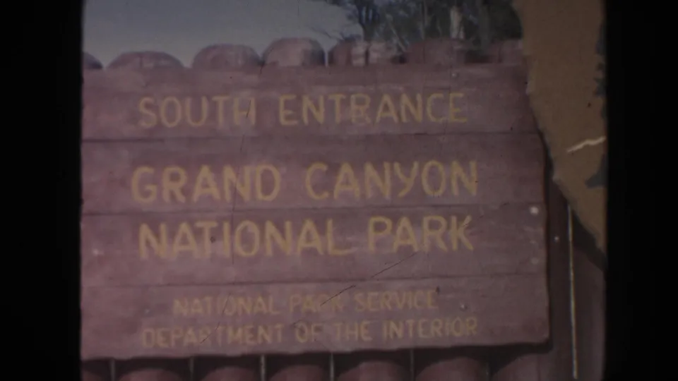 The South Entrance Grand Canyon National Park sign remains centered in a softly faded 1962 8mm home-movie frame.